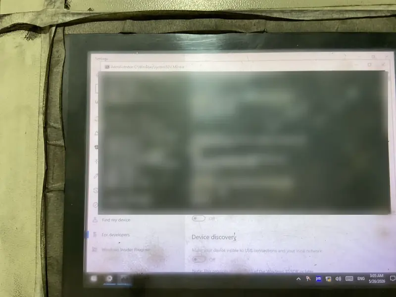 A machine's industrial panel PC screen, blurred for privacy